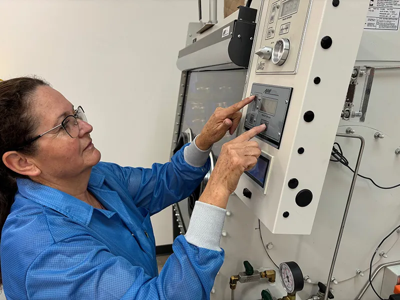 Worker using a glove box oxygen analyzer