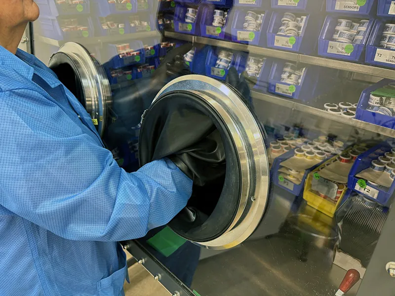Worker operating a glove box